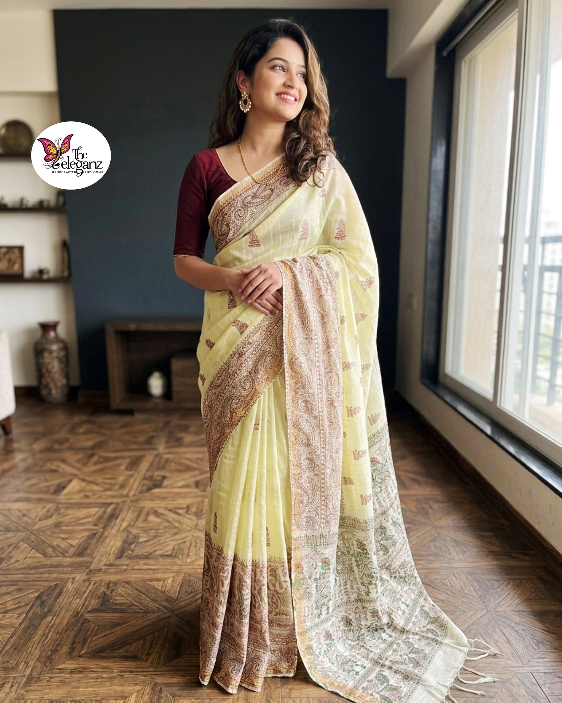 Woman draped in light lemon-yellow Cotton Silk Madhubani saree featuring traditional folk art figures, paisley motifs, and heritage-inspired decorative borders.